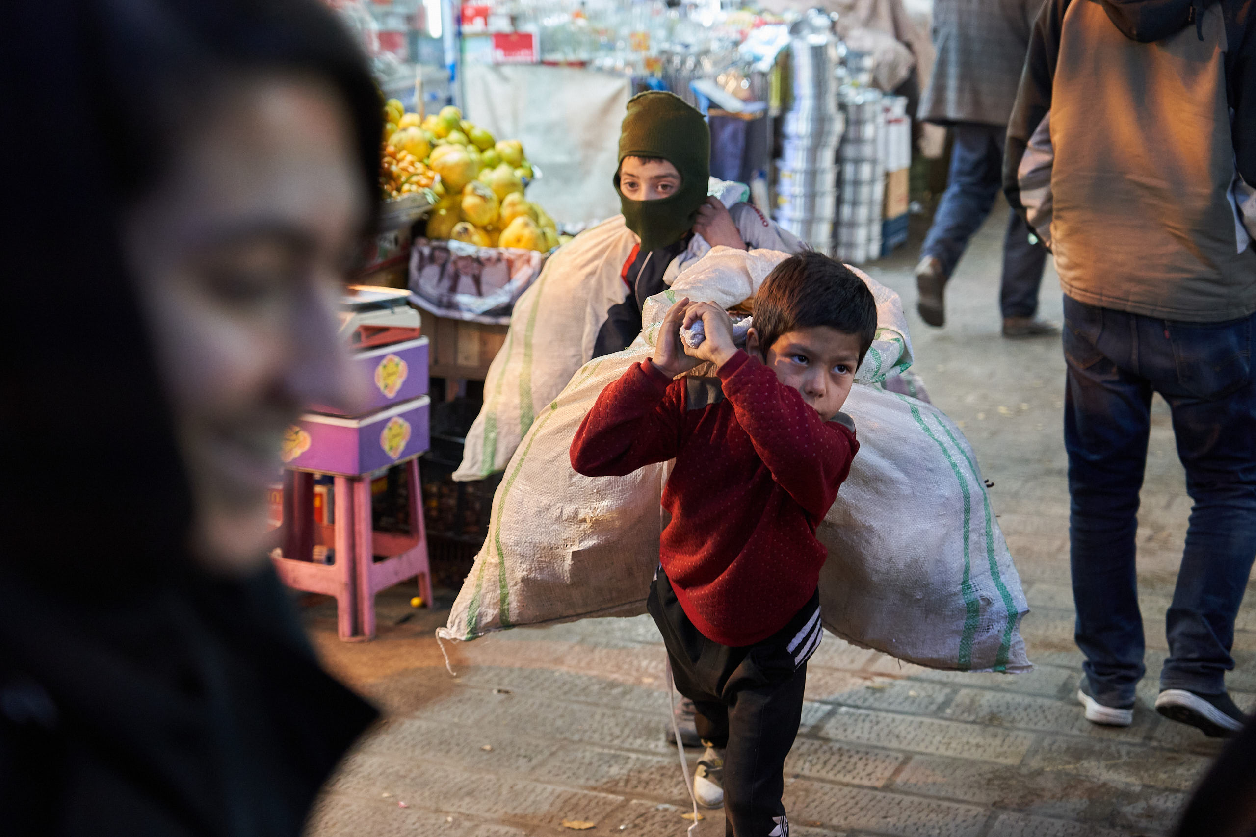 Two young boys working the evening to collect garbage